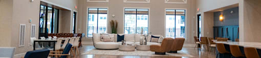 A large open living room with a high ceiling and wooden floors.