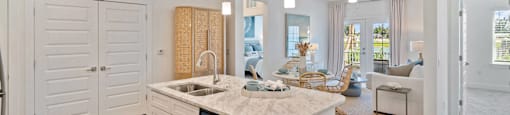 A modern kitchen with a large island and wooden floors.