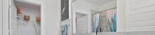 A bathroom with a white vanity and a white toilet.