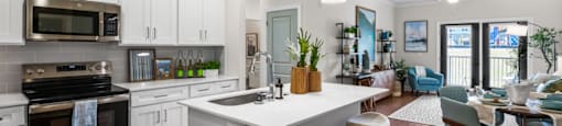A modern kitchen with a large island and bar stools.