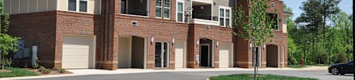 A large two story building with a parking lot in front.