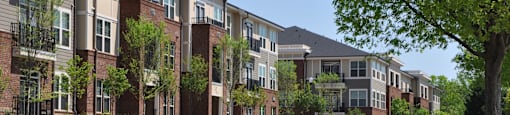 A street view of a residential area with apartment buildings on both sides.