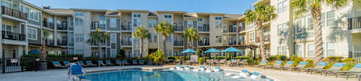 a swimming pool with an apartment building in the background