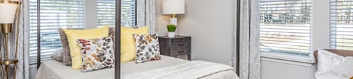 a bedroom with a bed and a ceiling fan