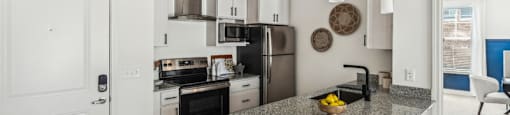 a kitchen with a counter top and a stove and a microwave