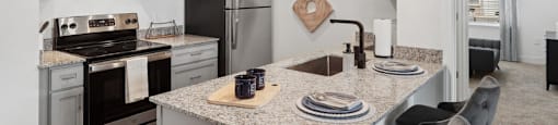 a kitchen with stainless steel appliances and granite counter tops
