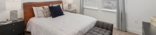 a bedroom with a bed and a large window