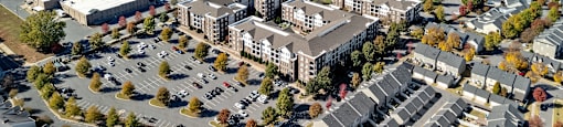 An aerial view of a large building complex surrounded by trees.