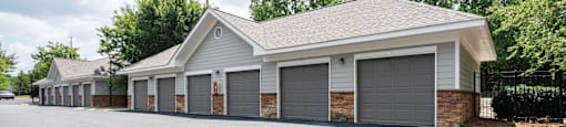 A building with a grey roof and grey garage doors.