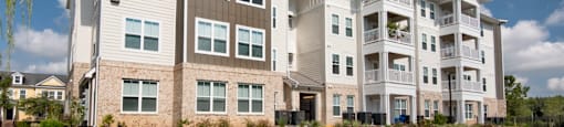 a picture of an apartment complex with a blue sky in the background