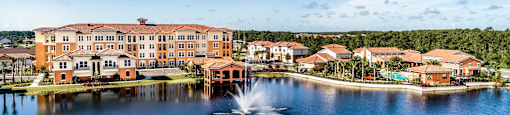 a fountain in the middle of the lake at the resort