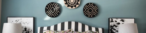 A bed with a striped pillowcase and striped pillows.
