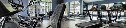 A gym with treadmills and exercise bikes.