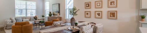 A dining room with a table set for six and a couch with a striped throw on it.