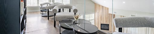 a living room with couches and chairs and a table