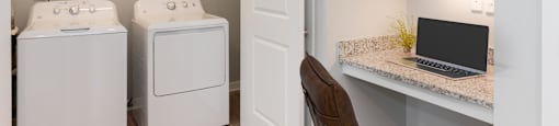 a desk with a laptop and a washer and dryer in a laundry room