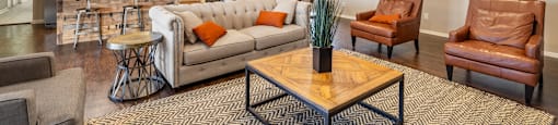 A living room with a brown leather couch and a wooden coffee table.