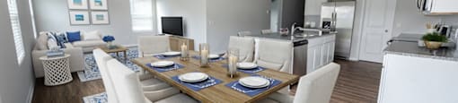 a dining room and living room with a table and chairs