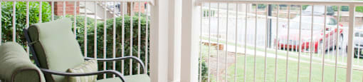 Two green chairs on an apartment patio at 1287 Shoals apartments in Athens, GA.