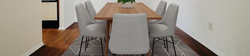 a dining room with a wooden table and chairs
