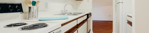 a kitchen with a white stove and a sink