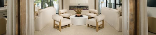 A living room with a white couch and a wooden ceiling.