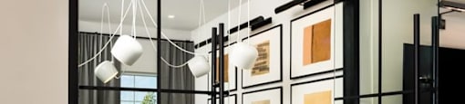 A glass door with a black frame leads to a dining area.