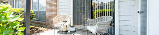A patio with a chair and a table.