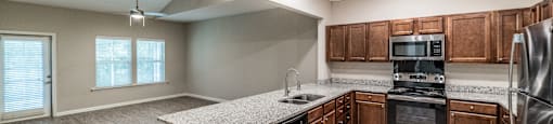 A kitchen with wooden cabinets and stainless steel appliances.