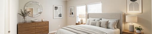 A bedroom with a large bed, a dresser, and a mirror.