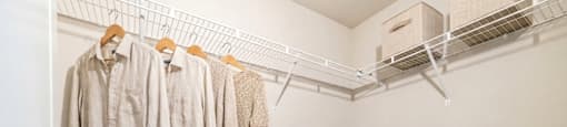 Clothes hanging on a clothes rack in a room.