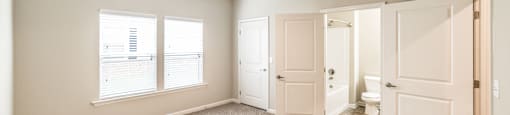 A room with a ceiling fan and carpeted floor.