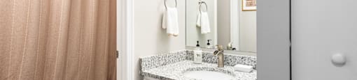 A bathroom with a toilet, sink, and shower curtain.