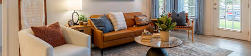 a living room with couches and a coffee table and a ceiling fan