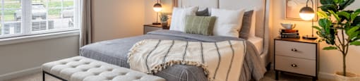 a bedroom with a bed and a curtain with grapes on it