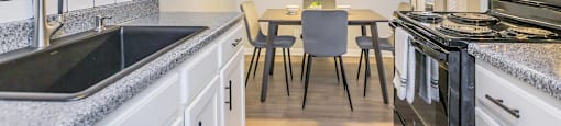 Upgraded kitchen and spacious dining space at Enclave at 38 Twenty Two Apartments in Greensboro, NC