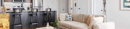 A modern living room with a beige sofa and a coffee table at Boardwalk at Research Park apartments in Huntsville, AL.