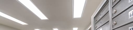 A room with a row of filing cabinets on the right and a row of filing cabinets on the left.