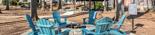 A set of six blue chairs are arranged around a table.