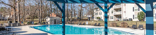A blue shaded area with a pool in the background at Madison Woods apartments in Greensboro, NC..