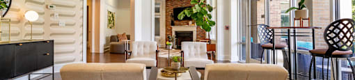 a living room with a table and chairs and a fireplace