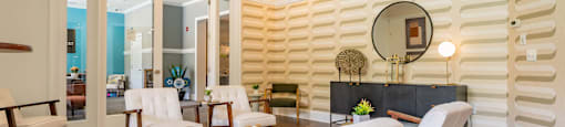 a living room with a table and chairs and a mirror