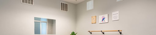 an empty room with a yoga ball and a table