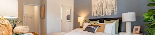 a bedroom with a large bed and a ceiling fan