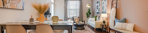 a living room with a dining room table and a ceiling fan
