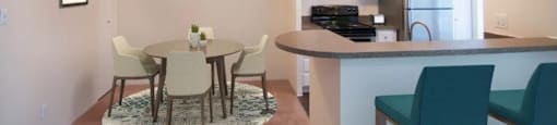 a dining room and kitchen with a table and chairs