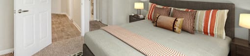 Spacious bedroom with plush carpeting and large window at Midora at Woodmont in Tamarac, FL