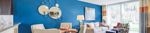 Living room and dining room area with plush carpeting and ample natural light in your home at Midora at Woodmont in Tamarac, FL