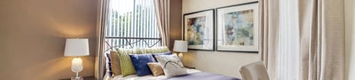 Spacious bedroom with plush carpeting and large window at Midora at Woodmont in Tamarac, FL