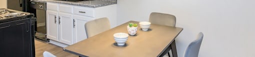 Dining space and table looking into kitchen at Enclave at 38 Twenty Two Apartments in Greensboro, NC